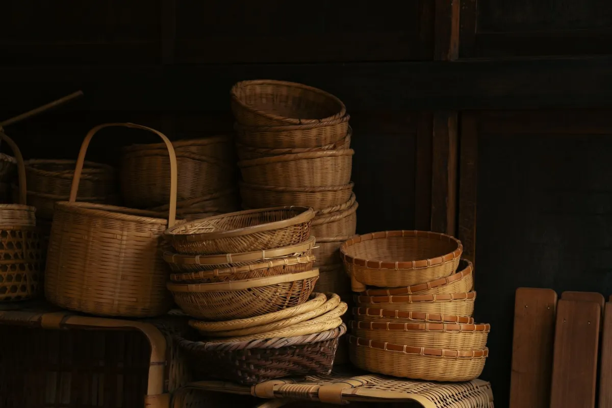 Traditional Japanese bamboo basket with intricate woven hexagonal pattern resting on wooden surface in natural daylight