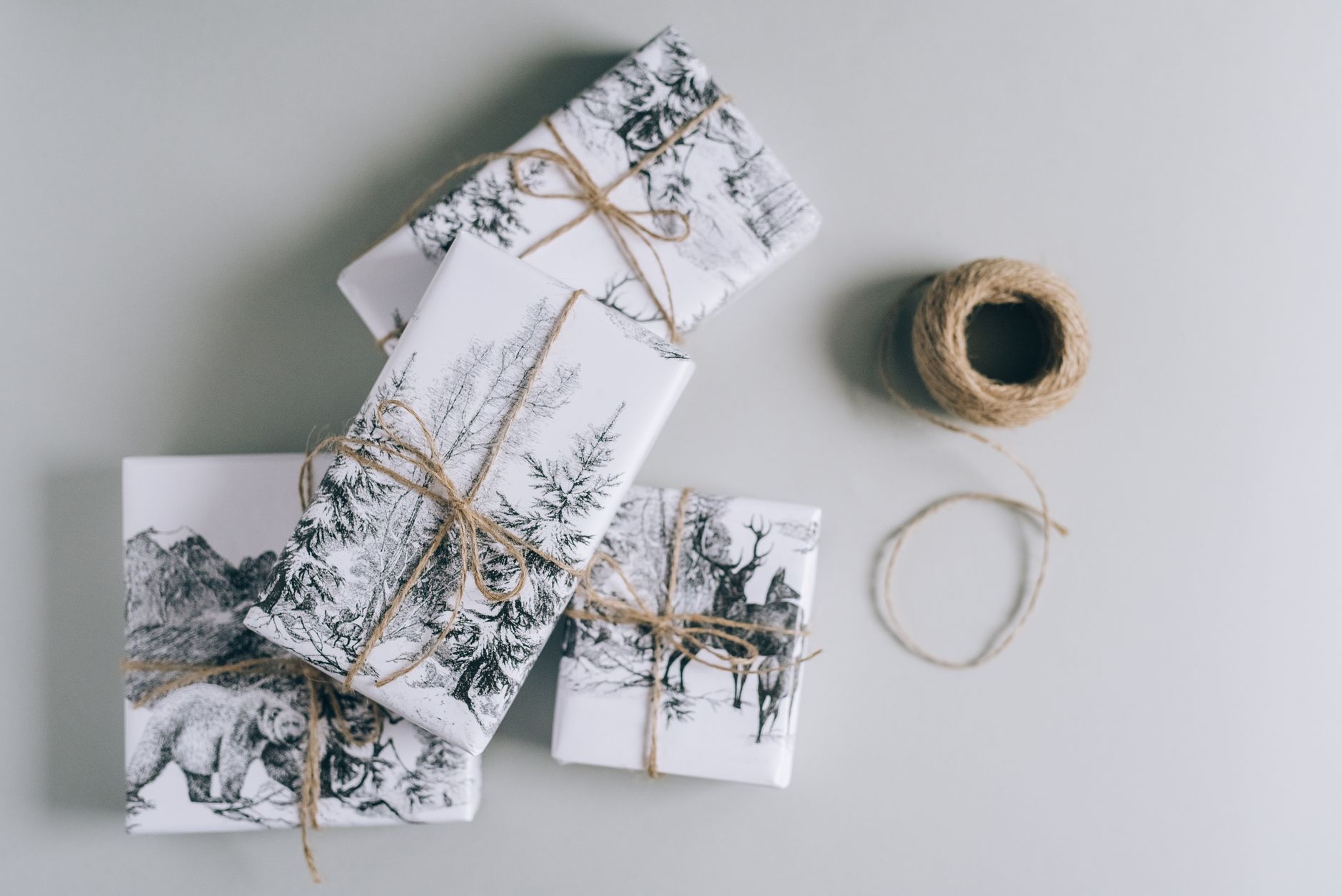 Colorful decorative envelopes with traditional Japanese patterns containing crisp bills, arranged beside pine and plum blossom New Year decorations.