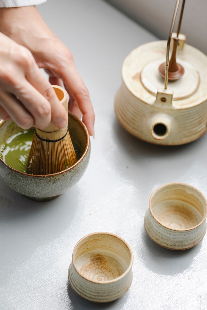 Traditional Japanese tea ceremony sunken hearth with glowing charcoal, iron kettle suspended above, surrounded by tatami mats in winter tearoom.