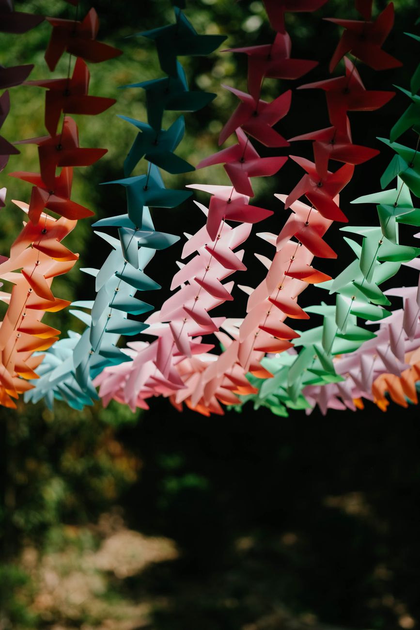 Colorful paper strips and origami decorations hanging from bamboo branches during Japan's summer Tanabata Star Festival celebration.