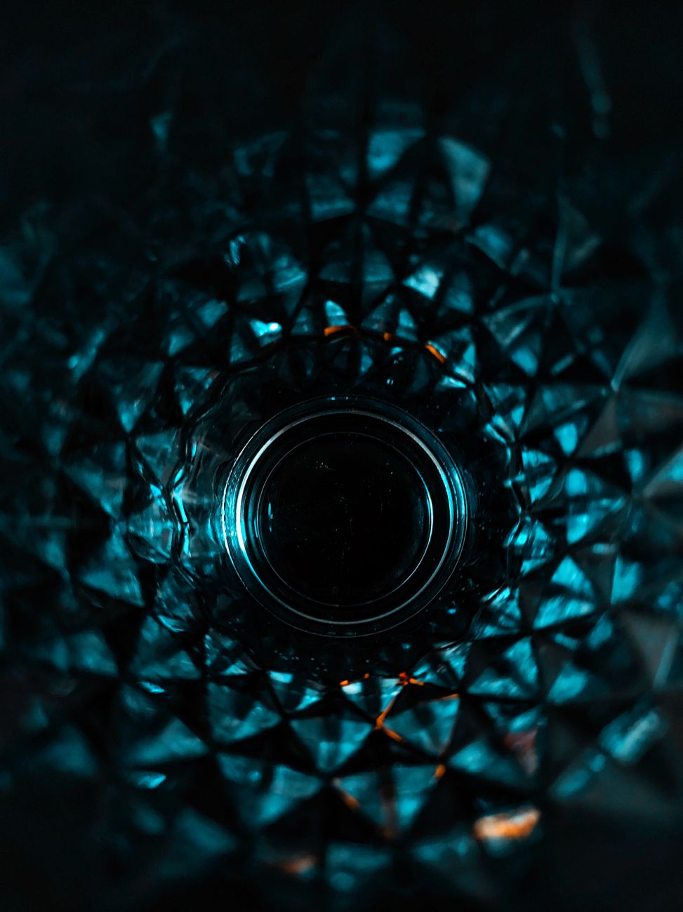 Traditional Edo kiriko cut glass displaying geometric nanako and yarai patterns with precise diagonal cuts catching light against dark background.