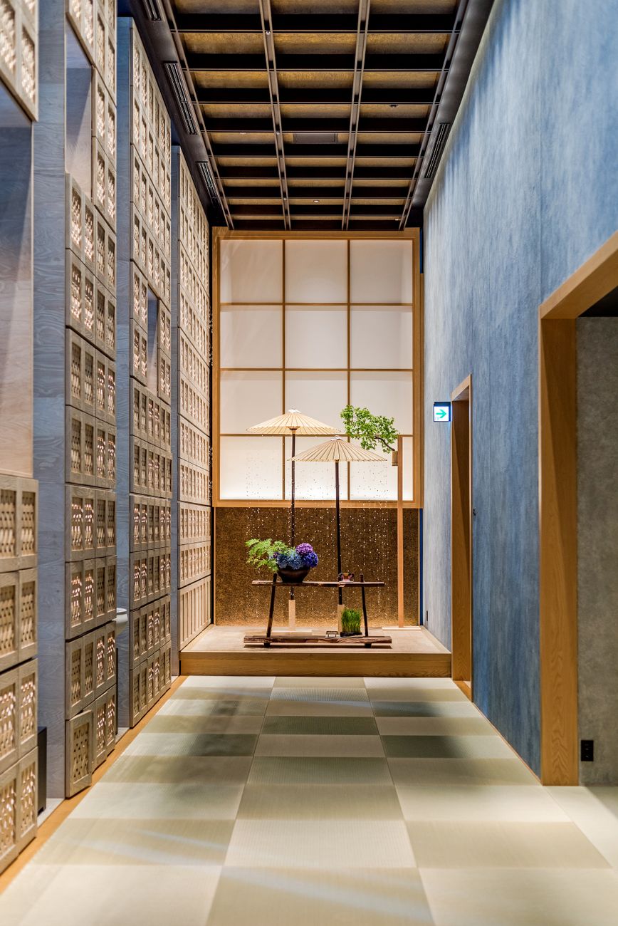 Traditional Japanese room with six tatami mats arranged in geometric pattern, shoji screens along walls, and low wooden table in center.