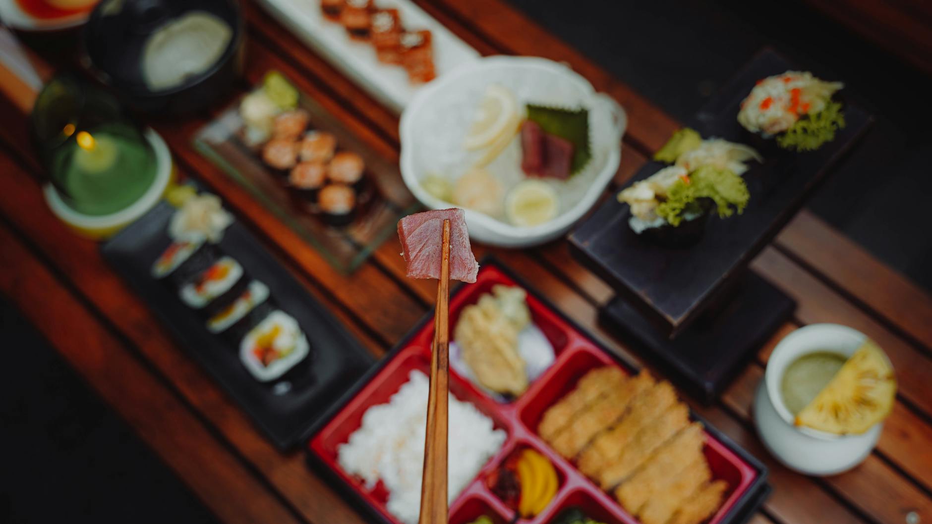 Traditional Japanese meal arrangement showing miso soup, rice bowl, grilled fish, pickled vegetables, and simmered dish on individual plates.