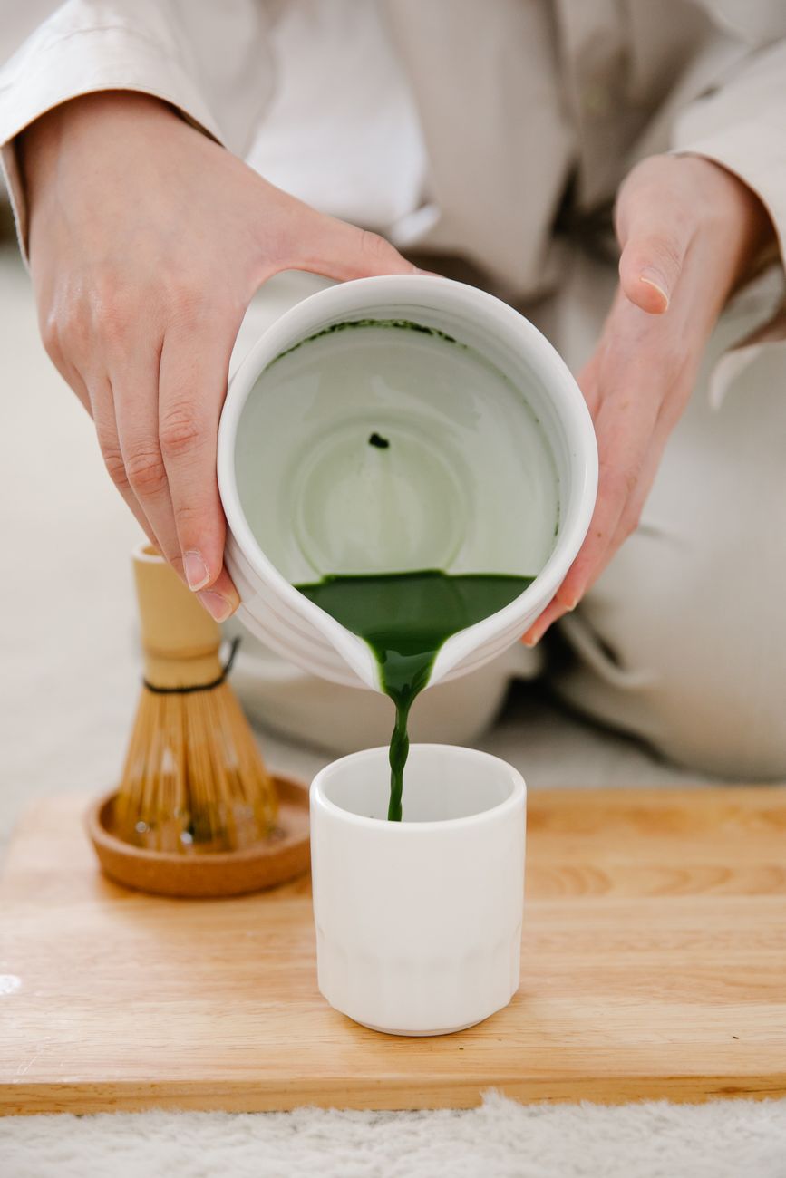 Bowl of thick koicha matcha beside thin usucha matcha showing contrast in consistency and foam texture during Japanese tea ceremony.