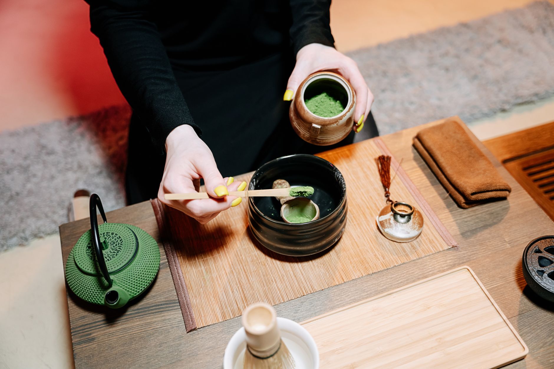 Vibrant green matcha powder in a ceramic bowl beside duller oxidized matcha showing quality differences through color comparison.