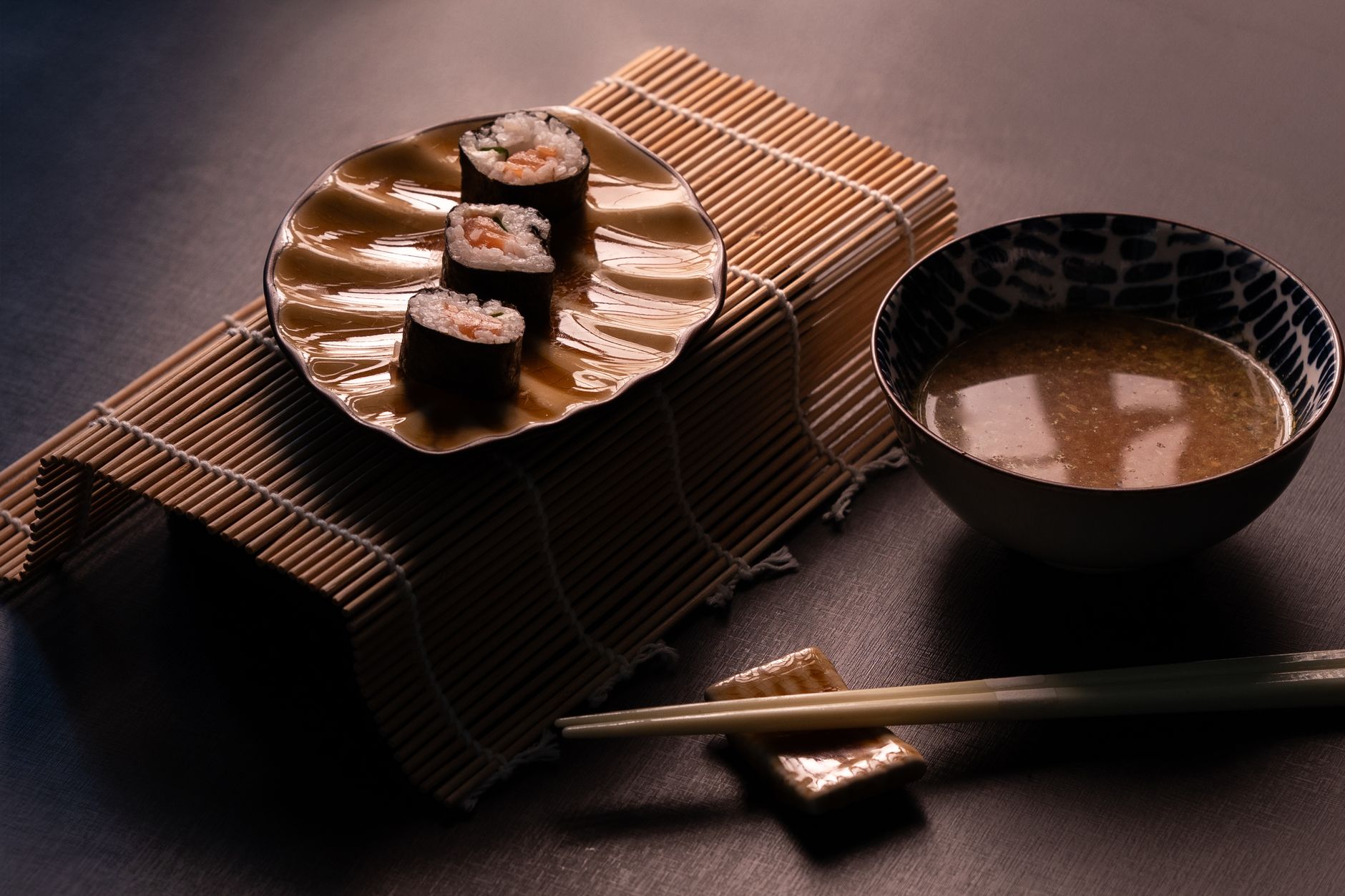 Glossy white sushi rice seasoned with rice vinegar, shaped into small oval mounds on a wooden cutting board.