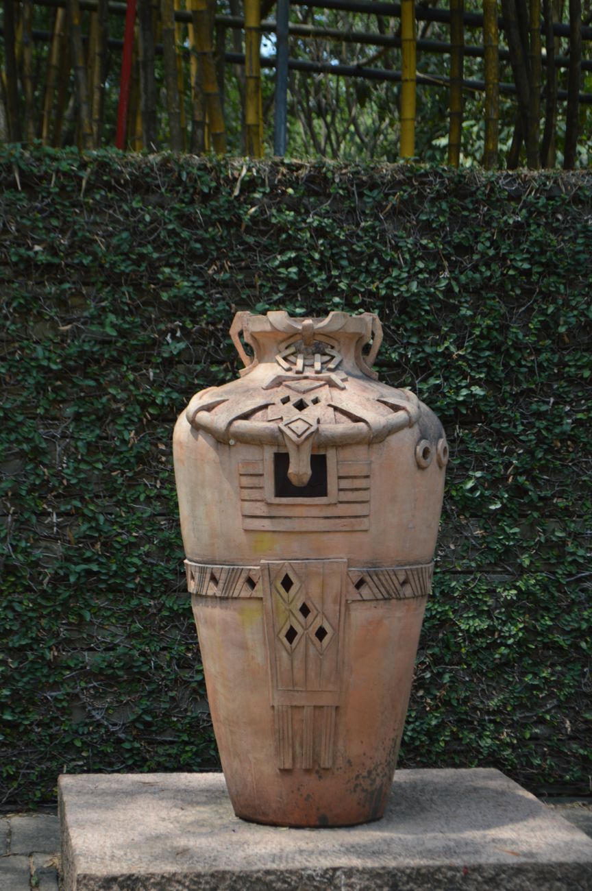 Ancient Jomon pottery vessel with distinctive rope-pattern cord markings and flame-like rim from Japan's prehistoric period.