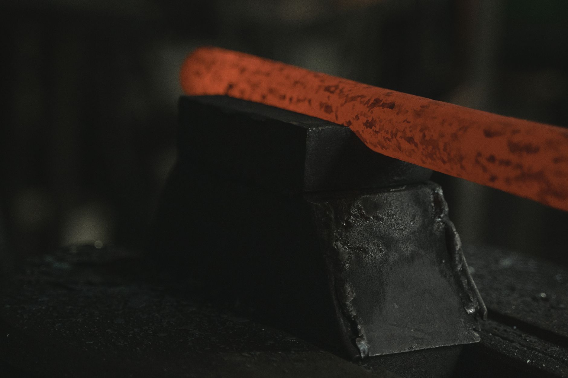 Traditional Japanese tatara furnace with craftsmen loading iron sand and charcoal to produce tamahagane steel for sword making.