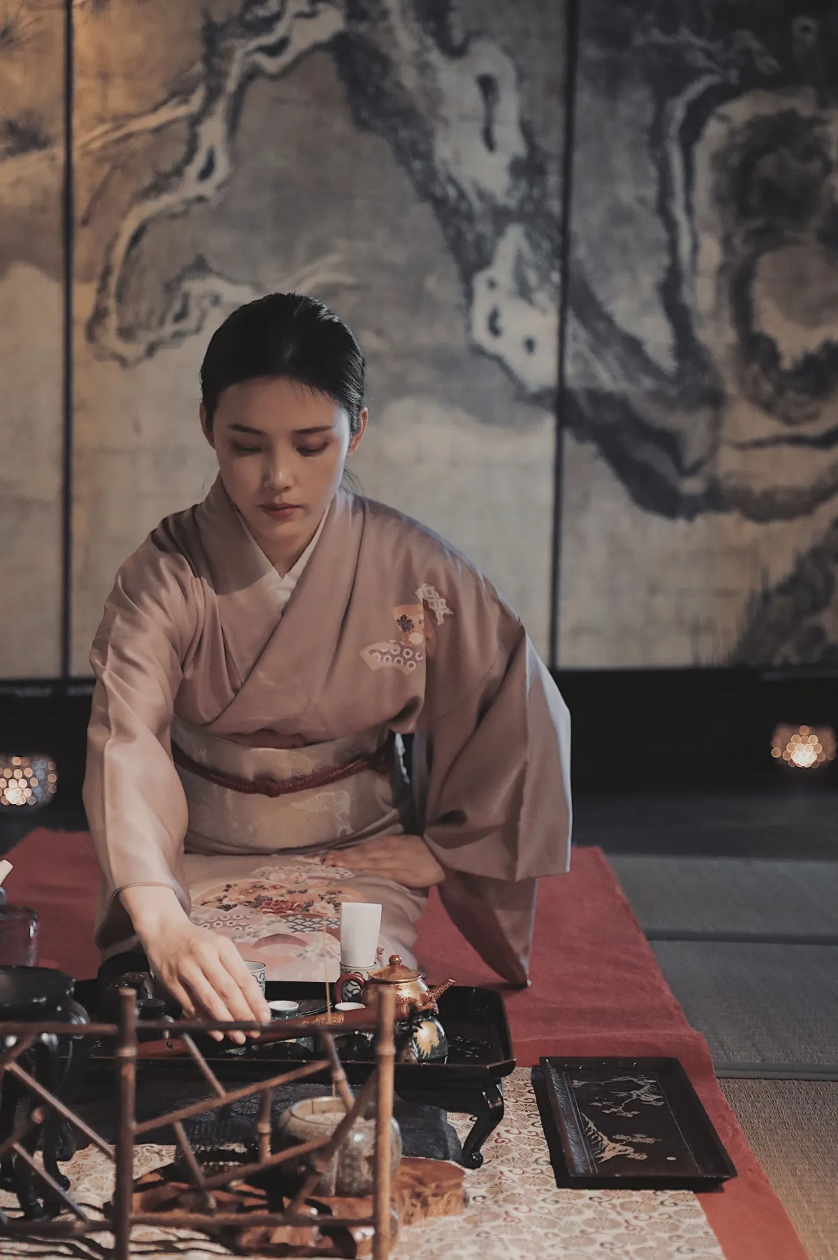Traditional Japanese tea room with tatami mats, sliding shoji screens, and a simple tokonoma alcove displaying minimalist flower arrangement.