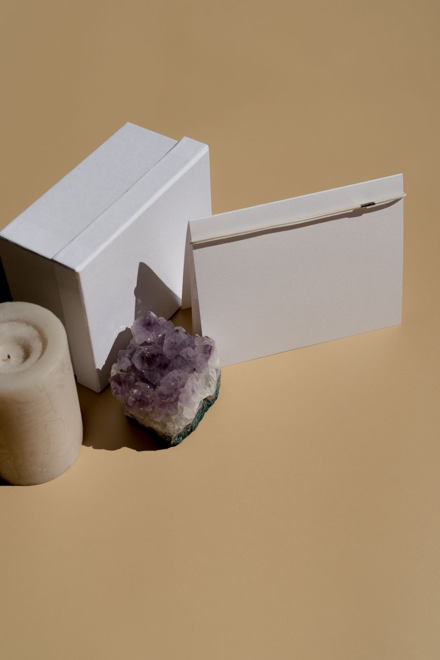 Wrapped gift boxes with traditional mizuhiki cord decorations arranged on a wooden table for Japanese seasonal gift-giving ceremony.