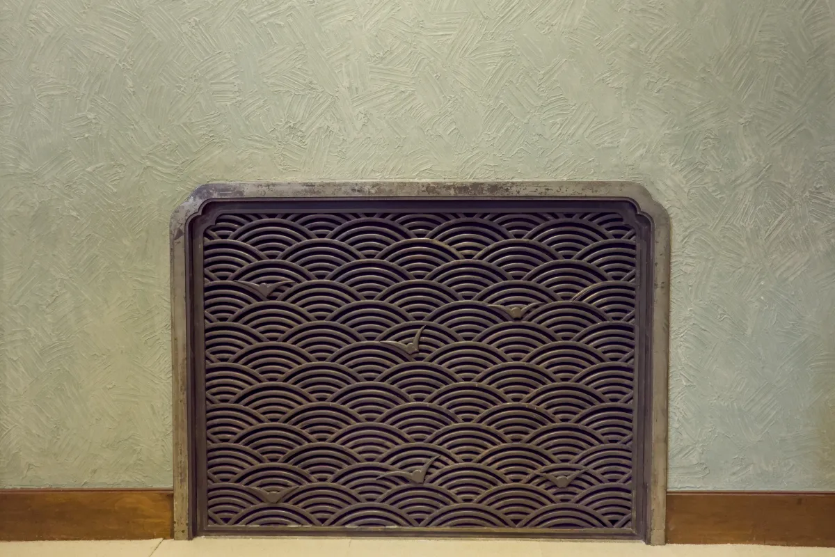 Overlapping semicircular waves in graduated blue tones create the traditional seigaiha pattern on Japanese ceramic pottery.