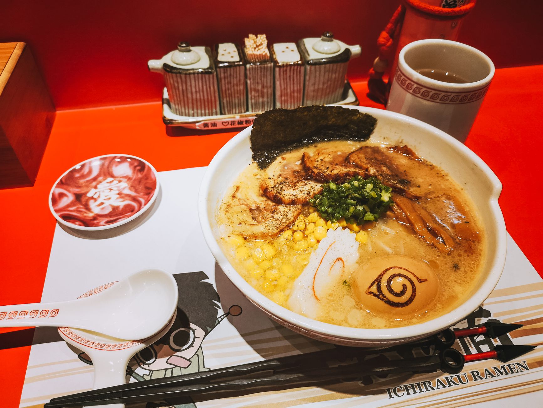 Bowl of dashi broth with kombu seaweed and bonito flakes visible, showing the foundational ingredients of Japanese umami flavor.