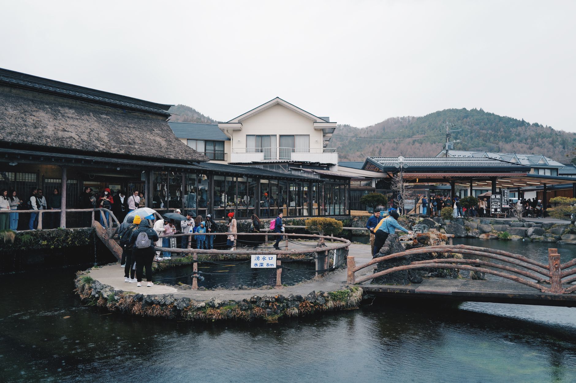 Historic Arita town street lined with traditional porcelain workshops and kilns nestled among forested hills in Saga Prefecture, Japan.