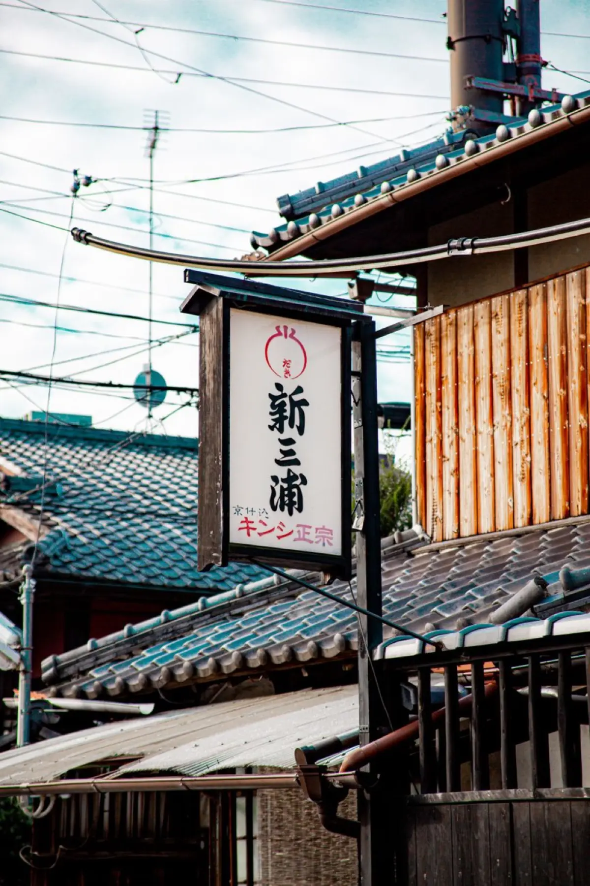 Historic Arita town street lined with traditional porcelain workshops and kilns nestled among forested hills in Saga Prefecture, Japan.