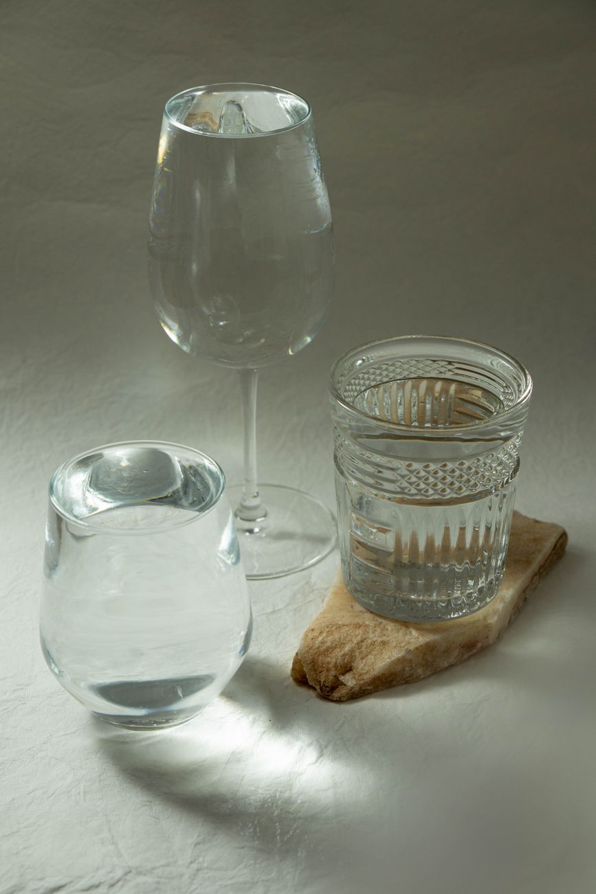Close-up of Edo Kiriko clear glass with geometric diamond cuts beside Satsuma Kiriko colored glass with deeper floral patterns.