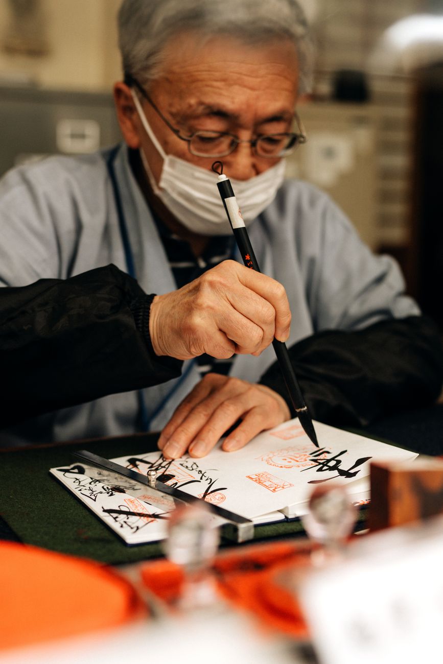Black ink brushstroke depicting bamboo stalks on white rice paper, showing varying tones from deep black to soft gray.