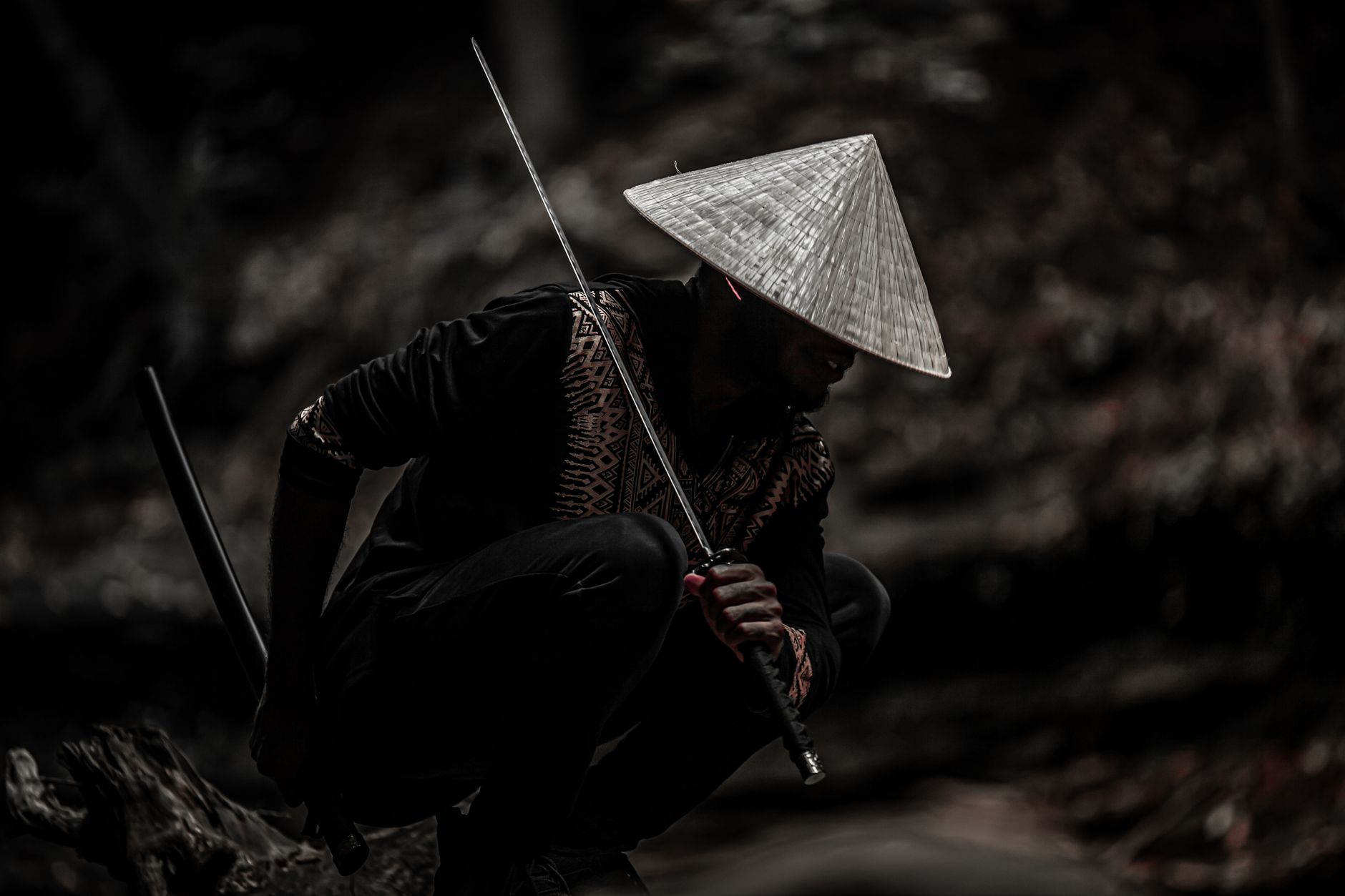 Samurai warrior in traditional armor standing in a wooden dojo, katana at his side, embodying feudal Japan's warrior class.