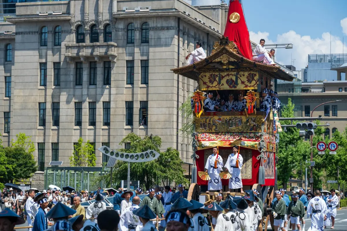 A lively Japanese street festival at night with lanterns, crowds and a portable shrine