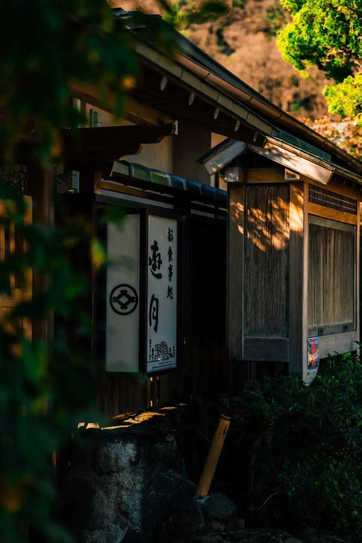 A steaming outdoor Japanese onsen hot spring pool surrounded by rocks and nature