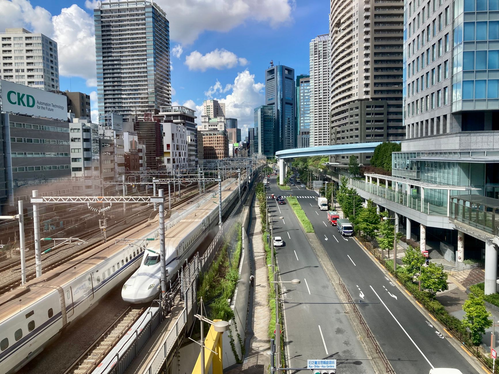Sleek white Shinkansen bullet train waiting at a spotless platform under a modern station canopy in Japan.