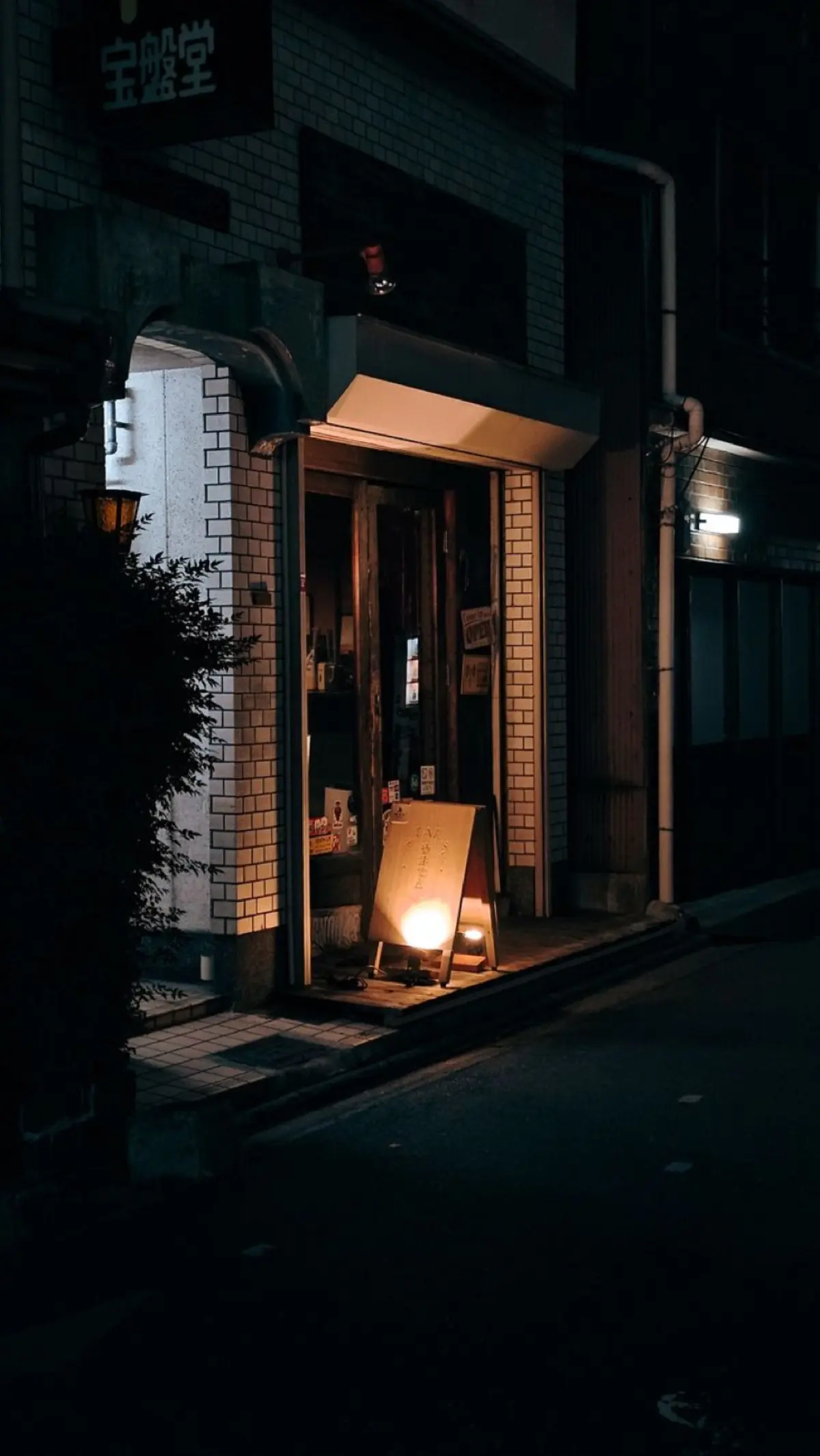 The bright interior of a Japanese convenience store at night, shelves neatly stocked with fresh food