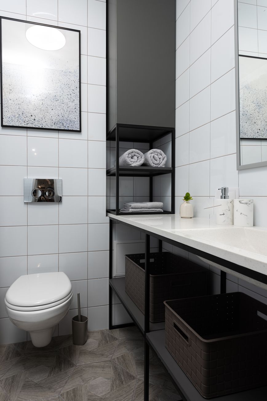 Modern Japanese toilet with electronic bidet control panel mounted on bathroom wall showing temperature and pressure buttons