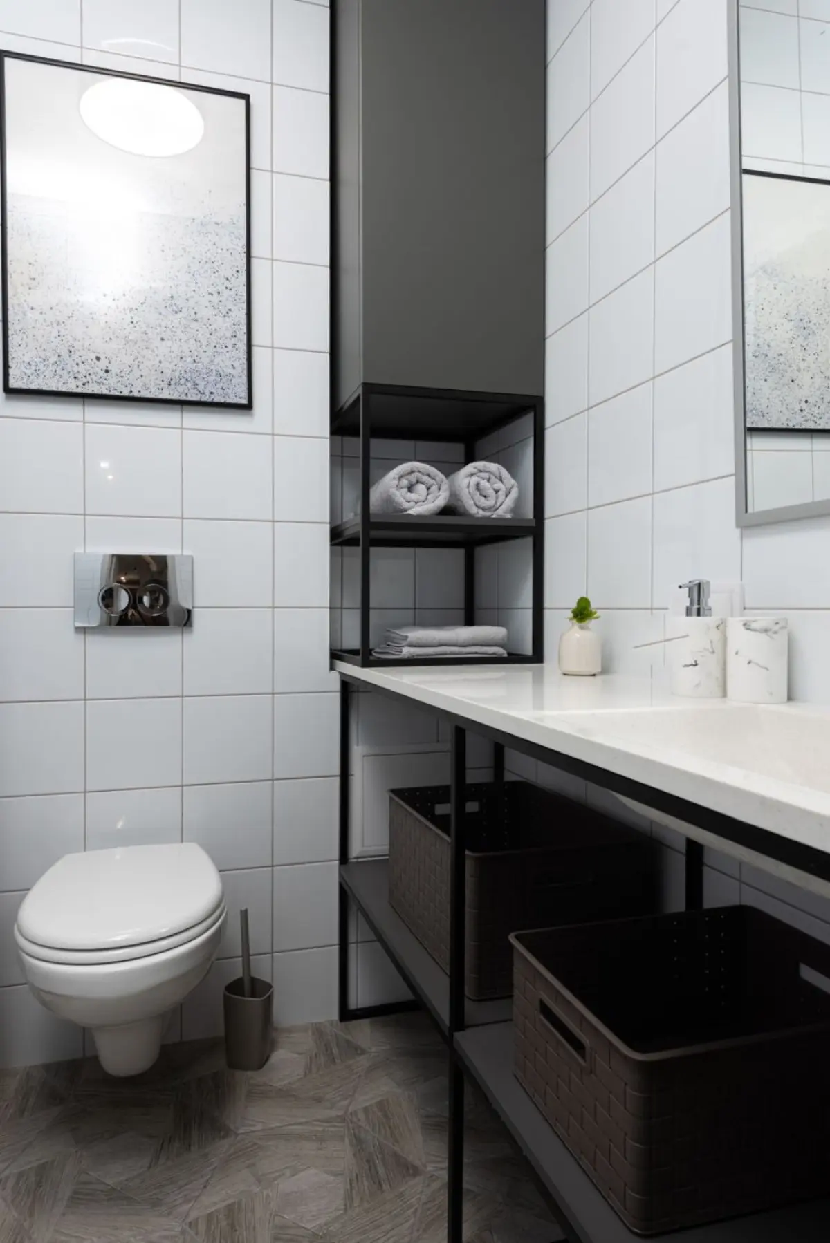 A modern Japanese washlet toilet with an electronic control panel on the wall beside it