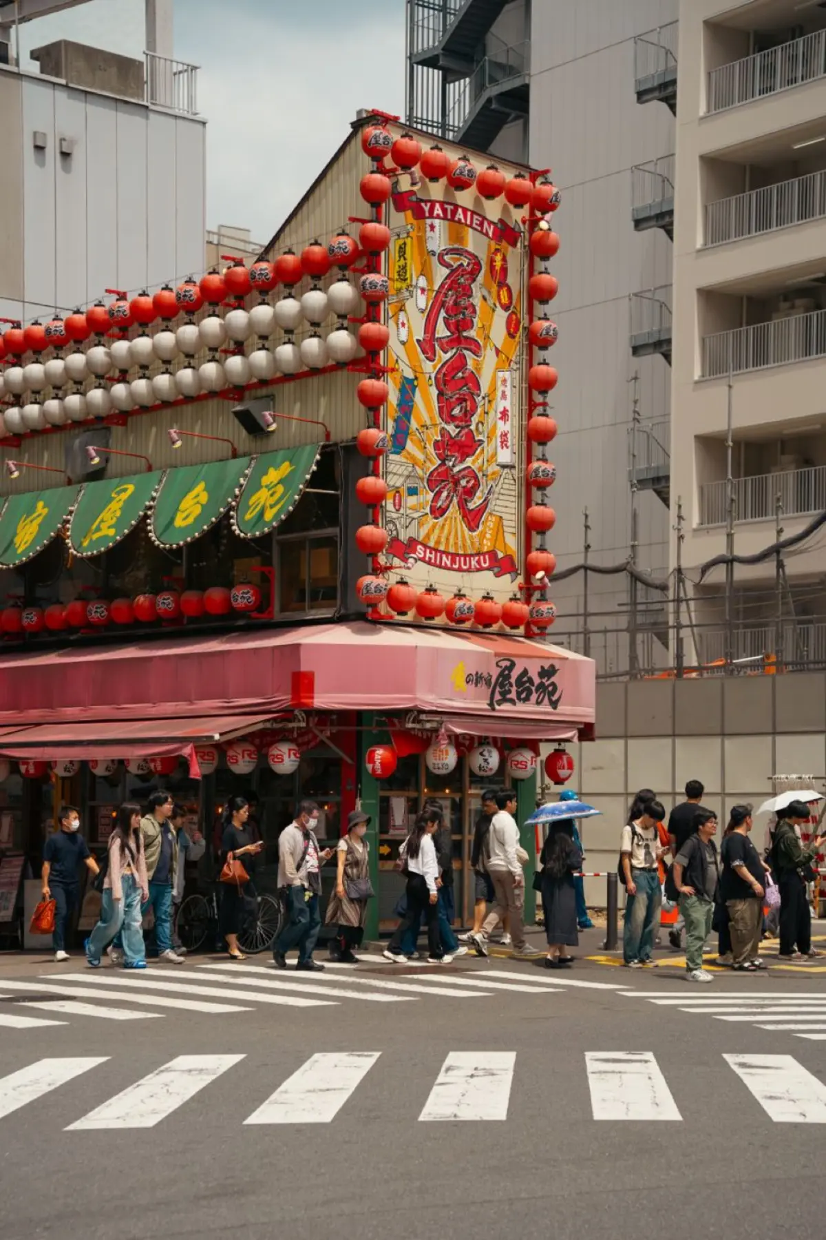Pedestrians crossing the famous Shibuya intersection in Tokyo with orderly lanes and no collisions during rush hour.