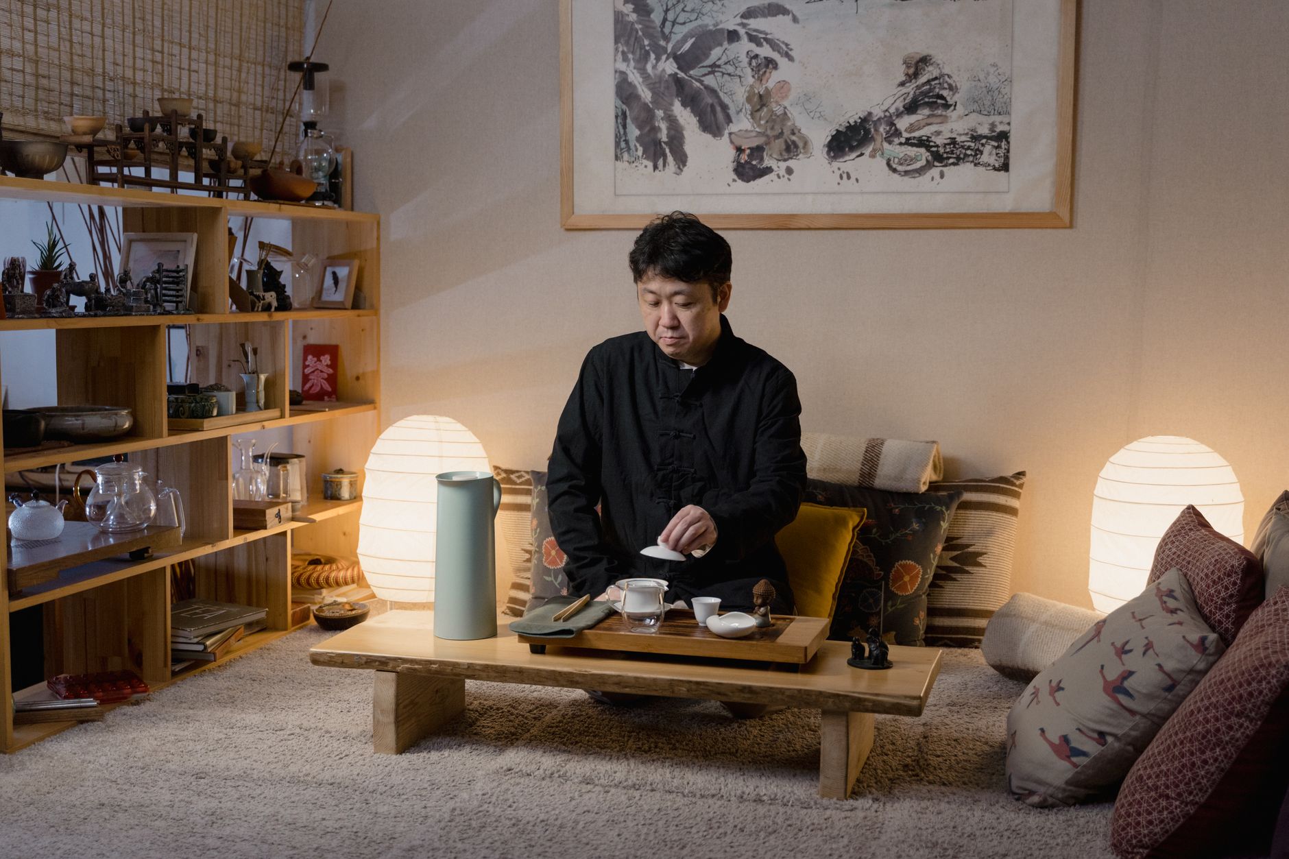 Family gathered around a low wooden kotatsu table covered with a thick quilted blanket in a traditional Japanese living room.