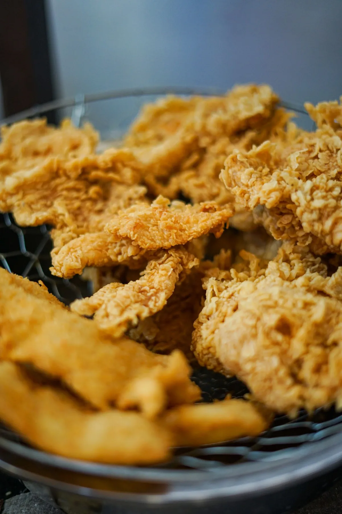 A red and white KFC bucket filled with fried chicken sits on a Japanese family's Christmas table with festive decorations.