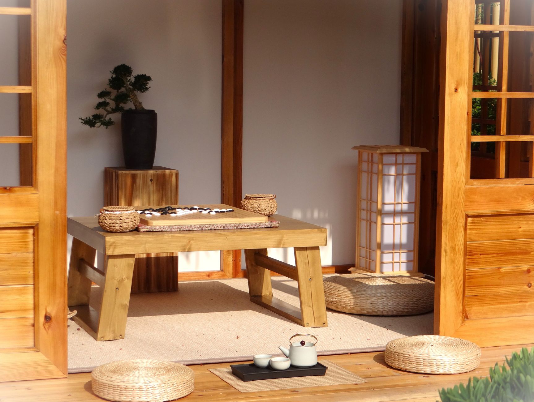 Traditional Japanese tatami room with woven rush mat flooring, sliding shoji screens, and low wooden table in minimalist interior.