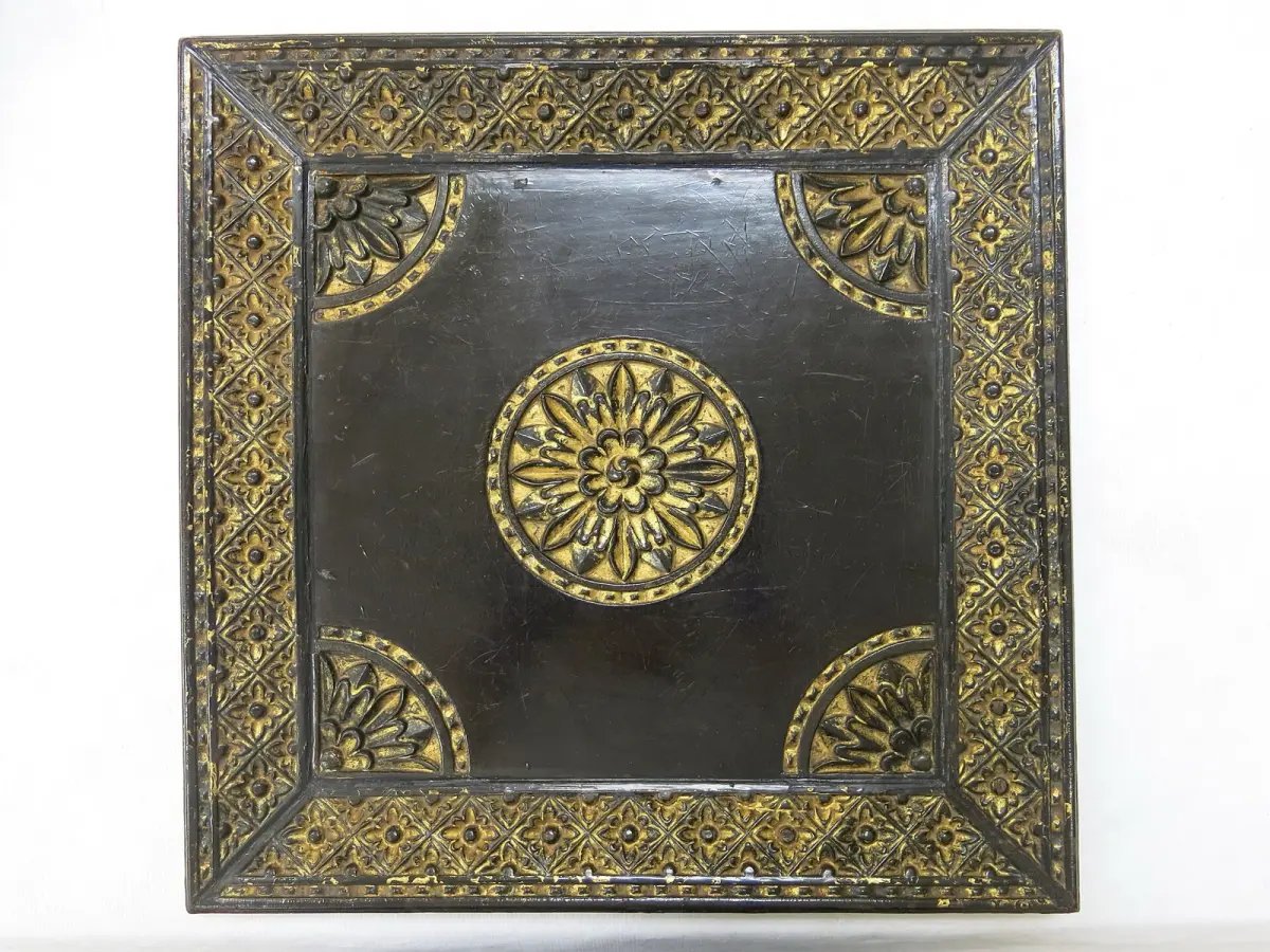 Carved red lacquer tray with peony flower relief pattern showing traditional Kamakura-bori technique from Japan's samurai heritage city.