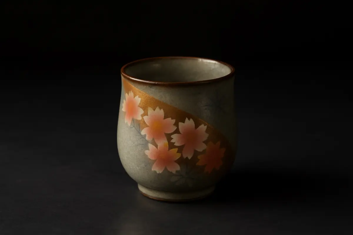 Weathered raku tea bowl with irregular black glaze and finger impressions showing wabi-sabi aesthetic principles of Sen no Rikyu's tea ceremony philosophy.