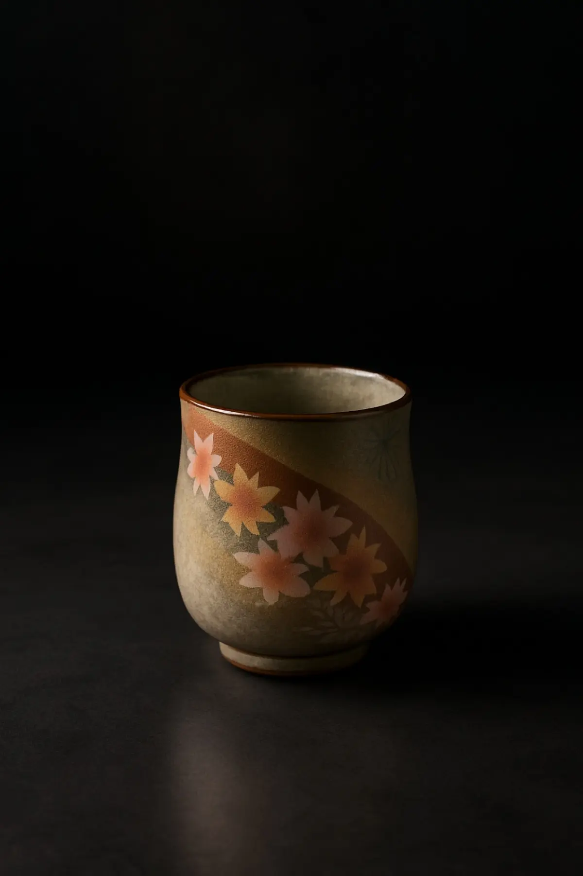 Weathered raku tea bowl with irregular black glaze and finger impressions showing wabi-sabi aesthetic principles of Sen no Rikyu's tea ceremony philosophy.