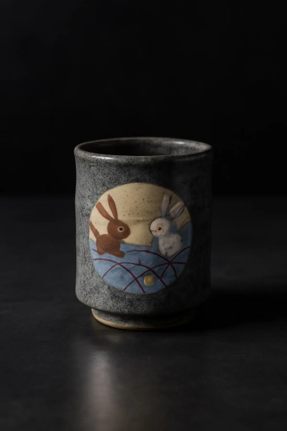 Shoji Hamada's rustic ceramic bowl with iron glaze and brush decoration exemplifying Mashiko folk pottery's mingei aesthetic principles.
