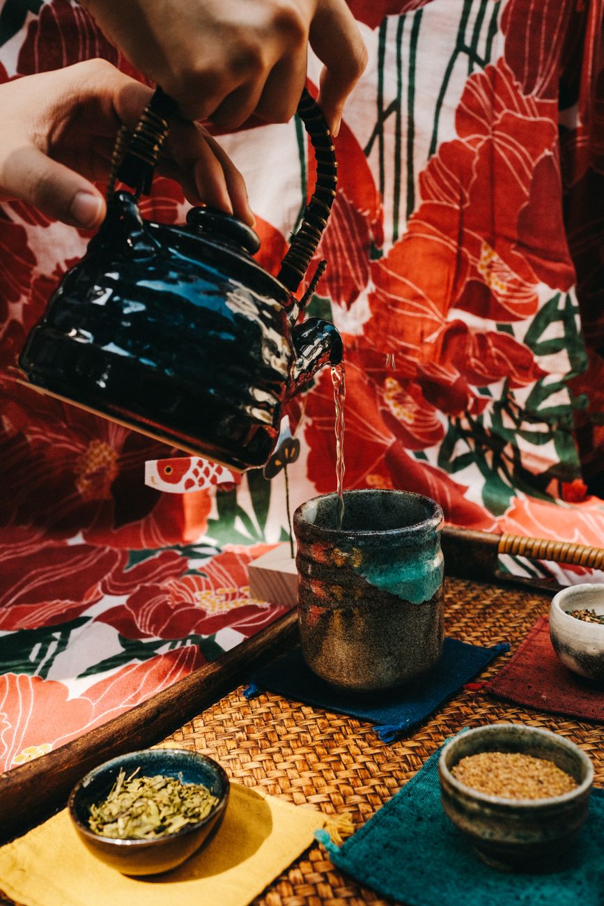 Roasted green tea stems and twigs in a ceramic Japanese tea cup showing golden amber liquid