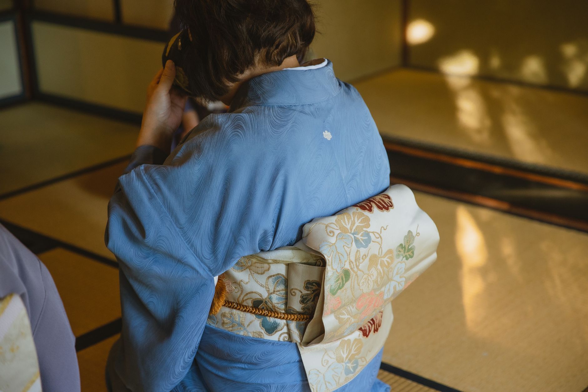 Samurai warrior in traditional hakama kneeling before a simple tea bowl in a minimalist tatami room during ceremony.