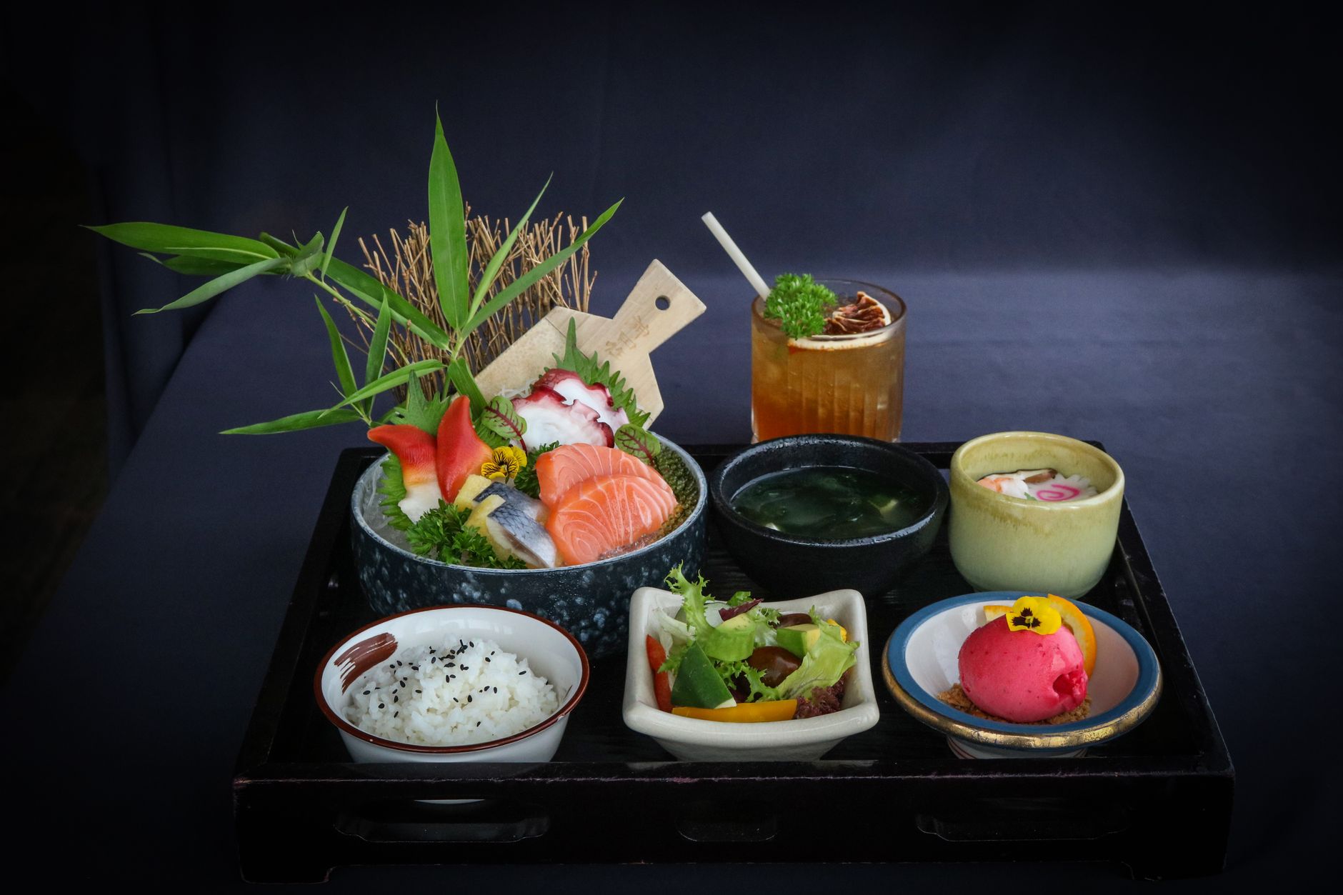 Traditional Japanese bento box displaying balanced compartments filled with rice, grilled fish, pickled vegetables, and colorful seasonal side dishes.