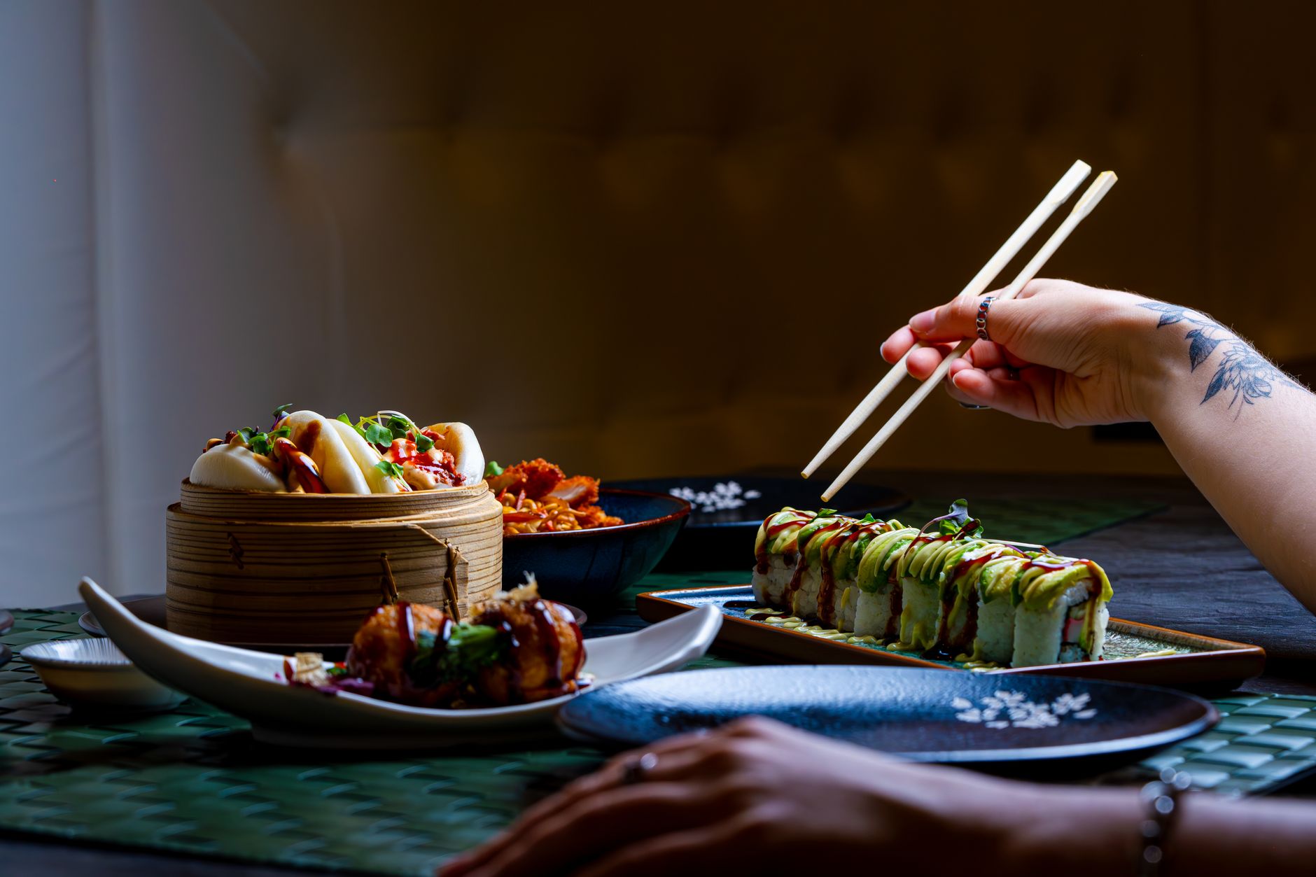 Minimalist kaiseki course presentation showing seasonal ingredients arranged on black lacquerware with negative space and natural garnishes.