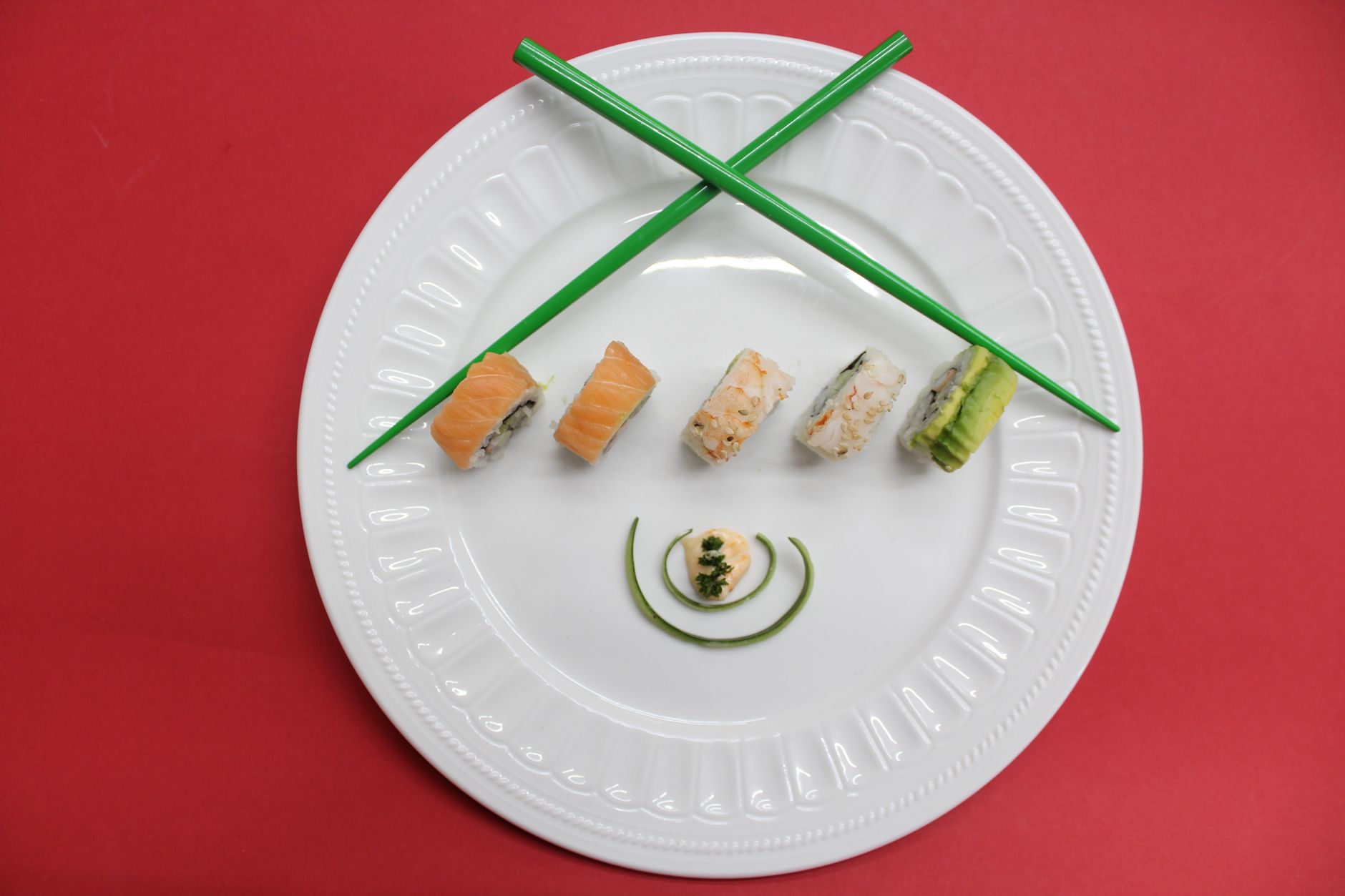 Fresh nigiri sushi arranged on natural hinoki cypress wood board with visible grain texture against dark background.