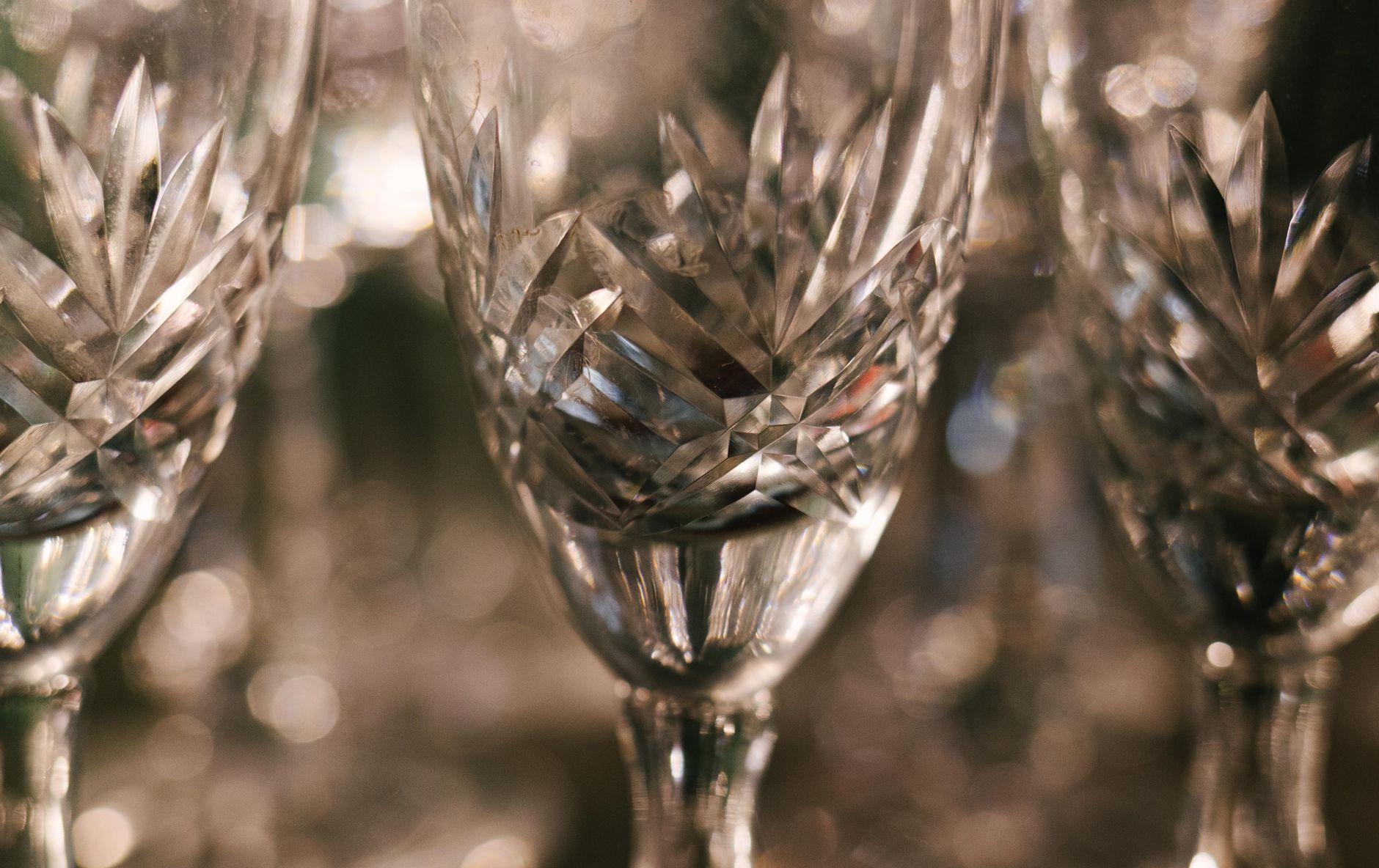 Close-up of intricate geometric cut patterns on traditional Japanese glassware, light refracting through faceted surface