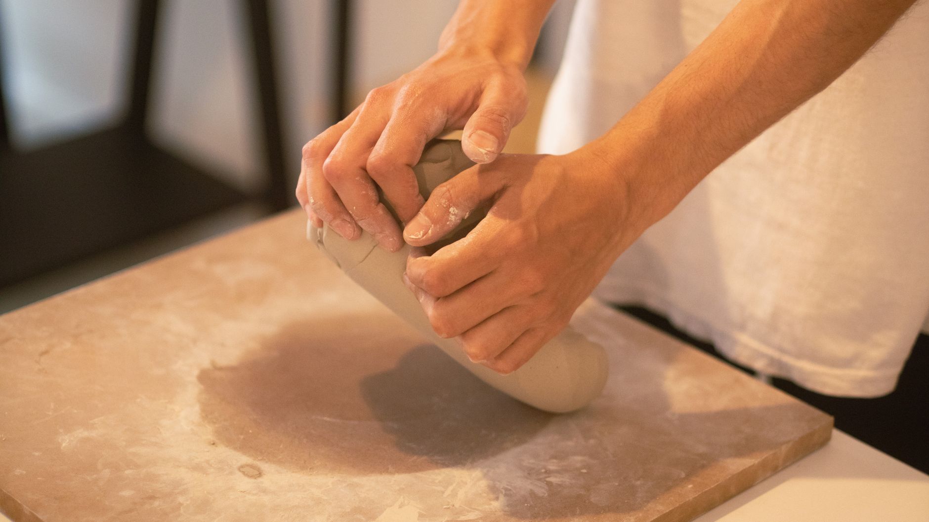 Close-up of a handmade ceramic bowl rim showing subtle finger marks and natural texture in the clay surface