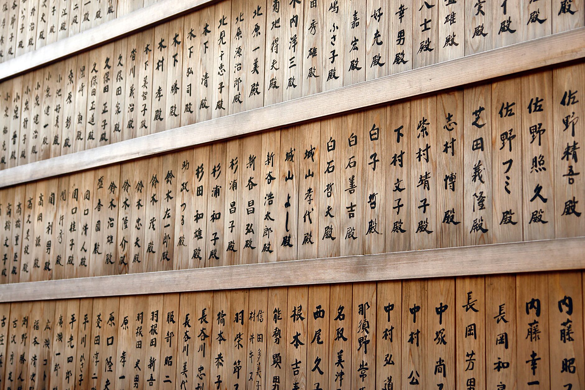 Calligraphy of the Japanese character 無 (mu) brushed in black ink on textured white paper in minimalist Zen style