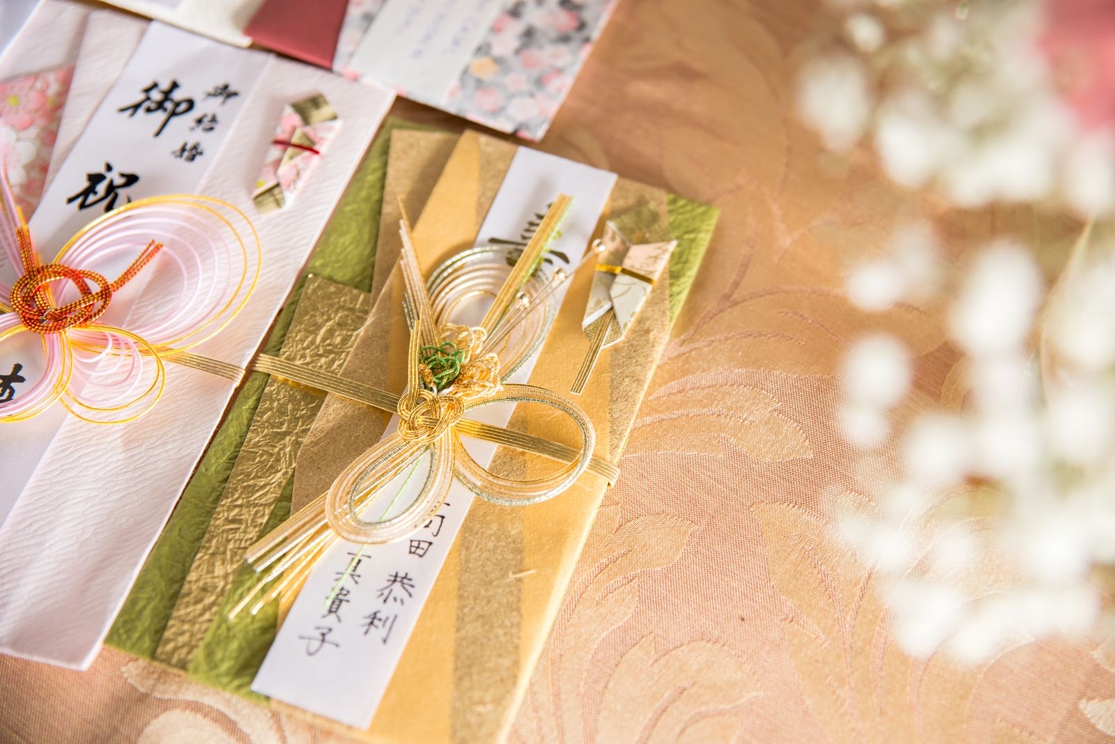 Elegantly wrapped Japanese gift box with traditional noshi paper and mizuhiki cord on a wooden surface