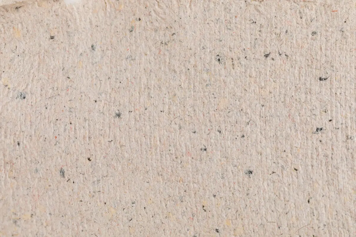 Sheets of handmade washi paper drying, showing soft fibrous edges and a warm natural texture