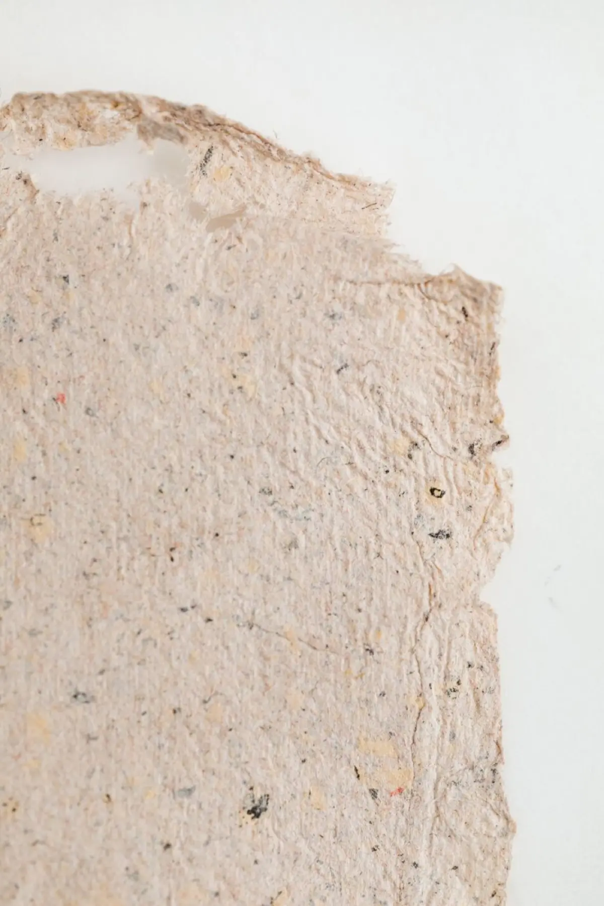 Sheets of handmade washi paper drying, showing soft fibrous edges and a warm natural texture